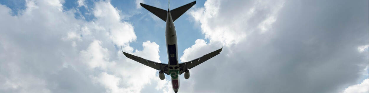 Commercial airplane landing at Rotterdam The Hague Airport as seen from below.